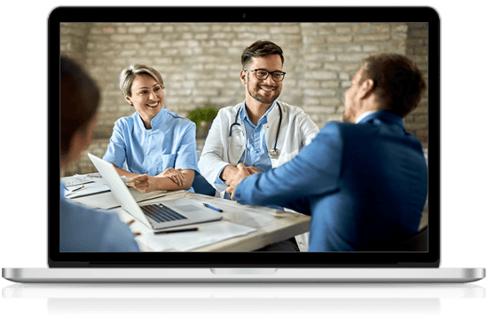 IT service providers shaking hands with healthcare providers in front of a computer