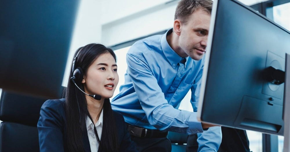 woman and man working on fixing poor IT support of a client