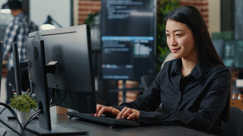 Woman at laptop using IT services for her Perth business